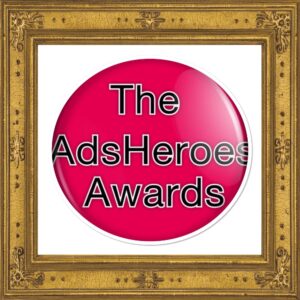 Badge saying The Ads Heroes Awards red in a gold frame